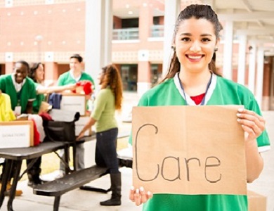 young girl holding a sign that says Care