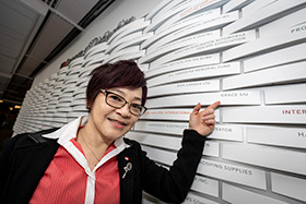 grace siu in front of donor wall