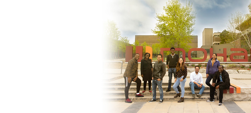 Group photo of students by the Mohawk sign at Fennell Campus