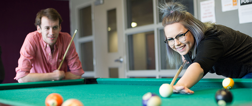 Two Mohawk students playing pool in the Mohawk Residence