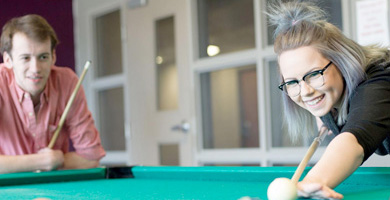 students in mohawk residence playing pool