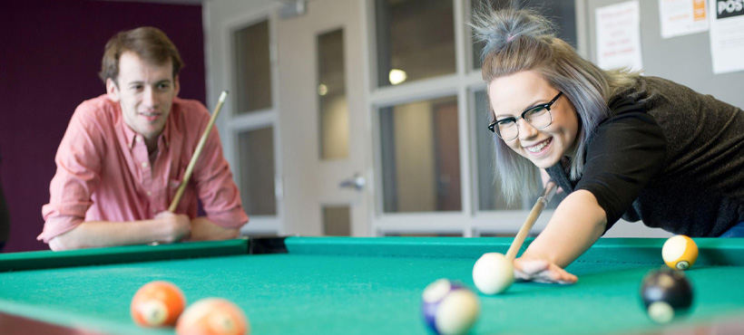 mohawk student's playing pool in residence