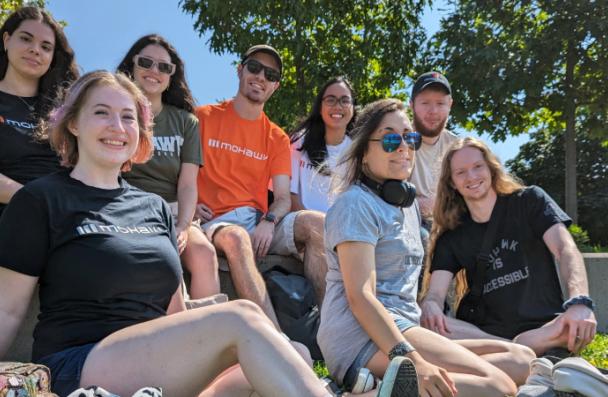 A group of Mohawk College students smile and pose for a photo.