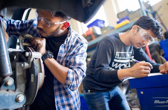 Students working on a car brake