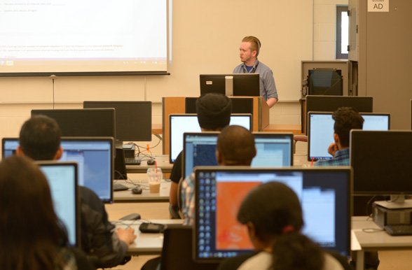 students with teacher in computer lab