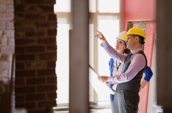Two engineering technologists examining the structure of a building.