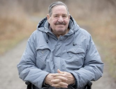 A man smiling while outdoors