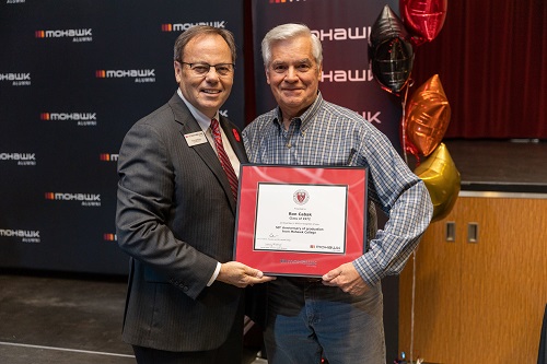 Ron Cabak holding a certificate beside President Ron McKerlie