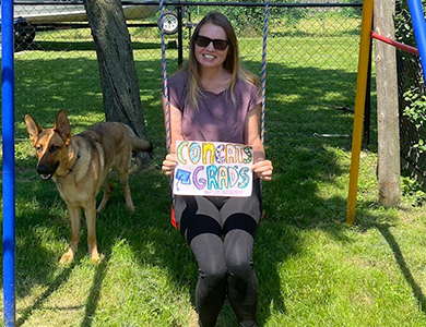 A lady named Stacey Money holding a sign