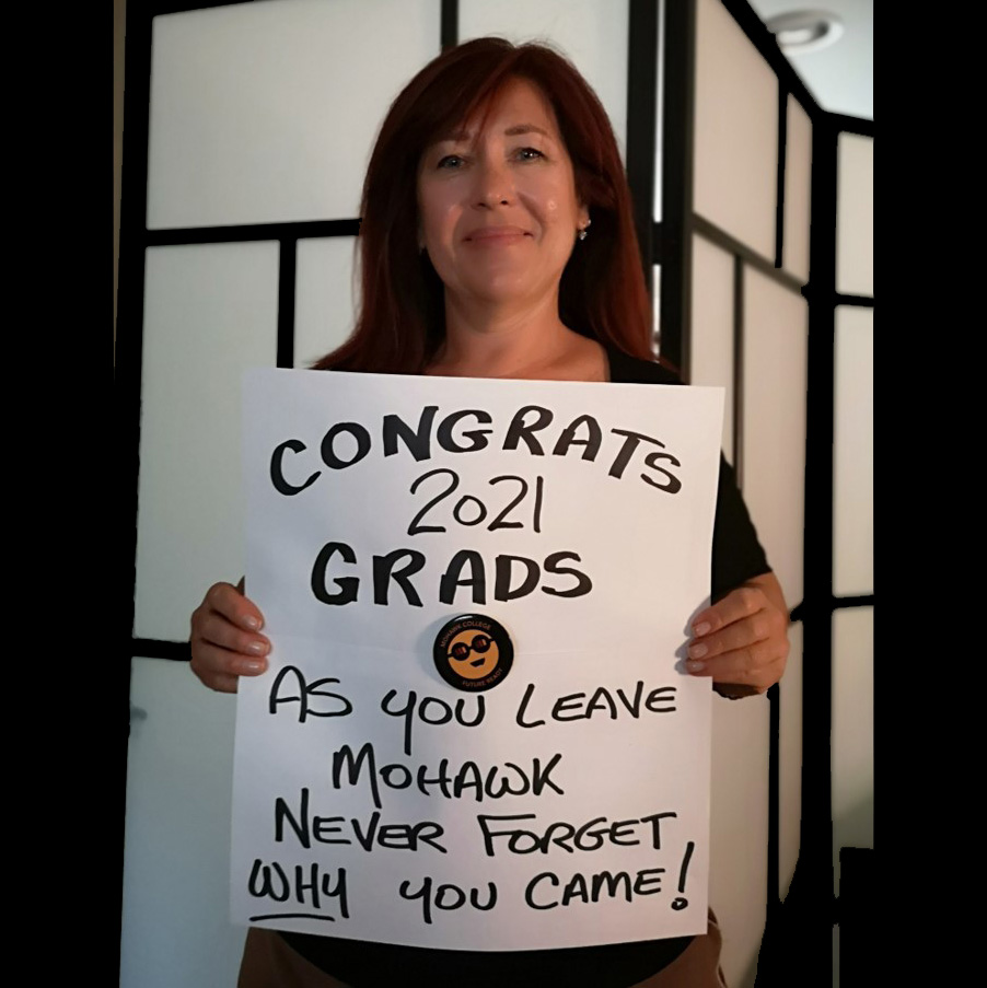 A lady named Vicky Webb holding a sign