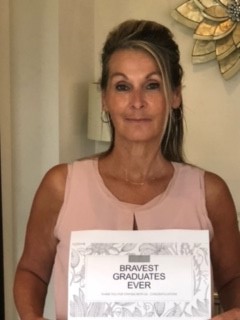 A lady named Wendy Fisher holding a sign