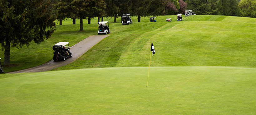 Golf course with people playing golf