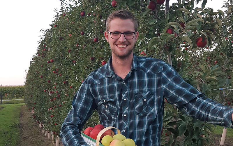 Mohawk alumni standing in apple orchard