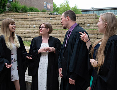 Four people talking outside