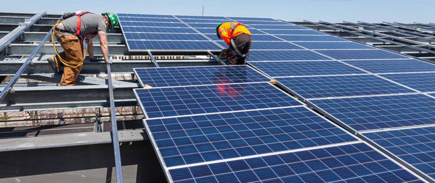 workers on a solar panel grid