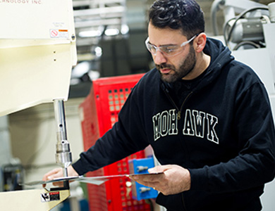 Man using metal stamping machine