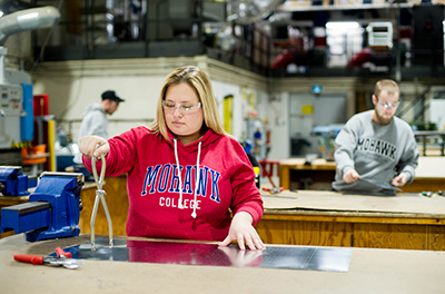 Woman working in the sheet metal lab