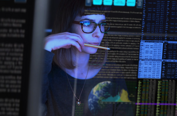 screen of data with a woman in the background
