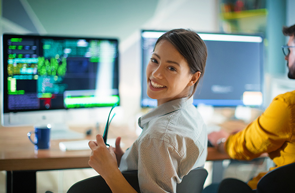 a person at a desk with a monitor in the background