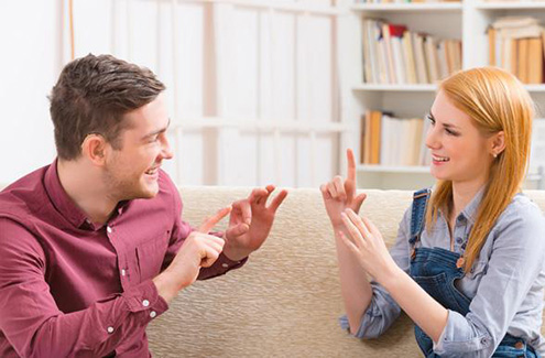two people communicating using sign language