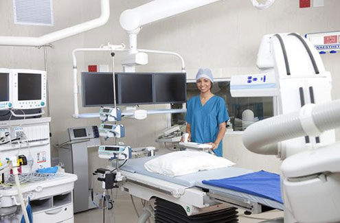 a woman wearing scrubs in an operating room