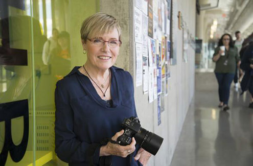 a woman with a camera ready to take pictures