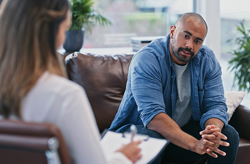 a man talking to a counsellor