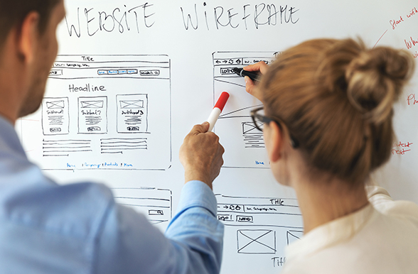 people working on website design at a whiteboard
