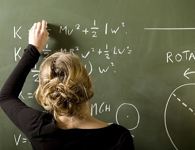 student working on a math problem on a chalkboard