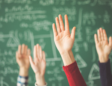 raised hands with a chalkboard