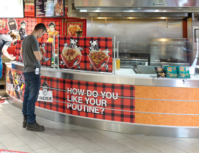 A student standing and looking at a food vendor