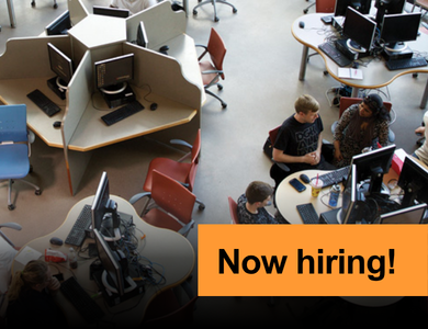 Aerial view of students studying on campus with banner overlay that says now hiring!