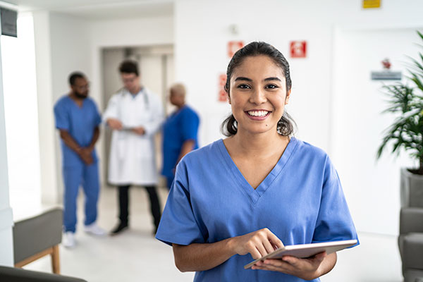 Nurse holding a clipboard and smiling