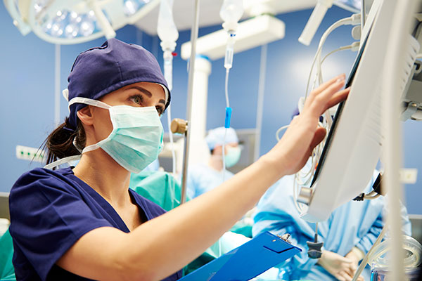 Operating Room Assistant working on a medical device