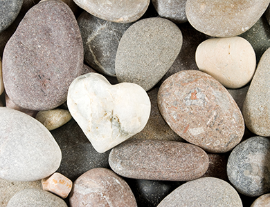 Heart shaped stone amidst various stones