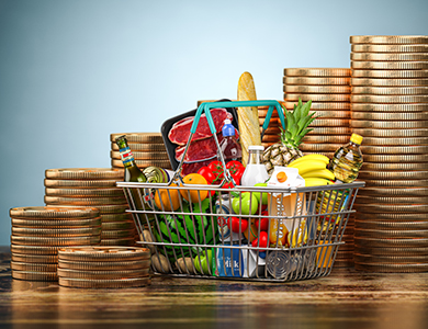 Stack of coins and a basket with groceries and food