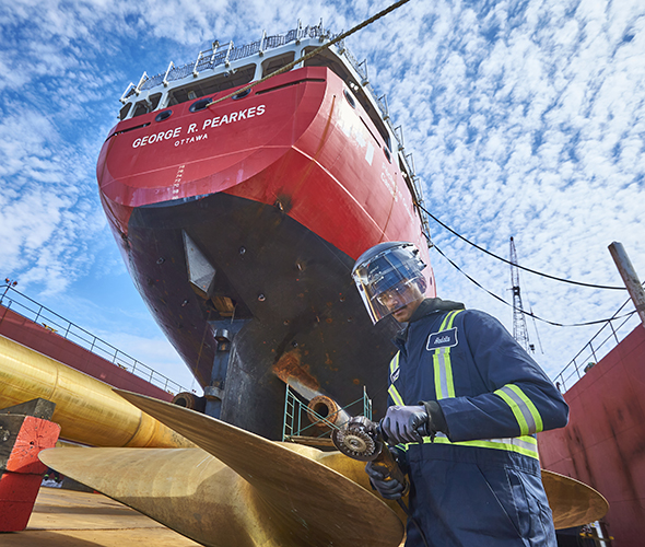 Worker performing helix part repair at shipyard