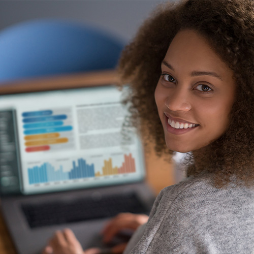 woman reviewing her finances on laptop