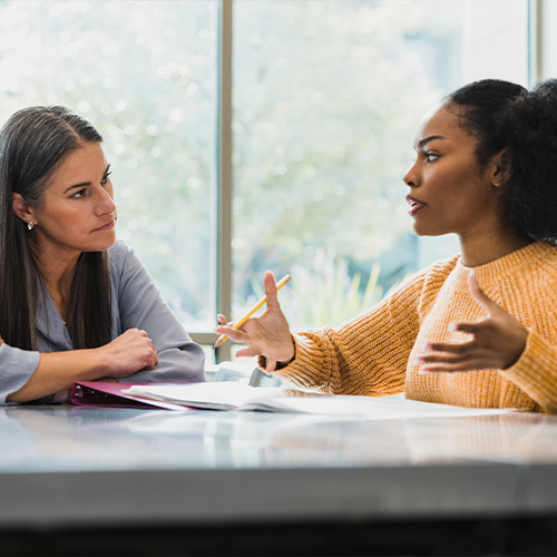 a student and teacher discussing finances