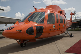 orange helicopter on runway