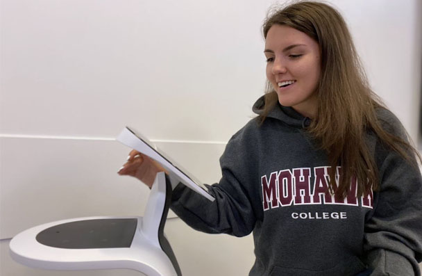 Degree student working a TEMI robot