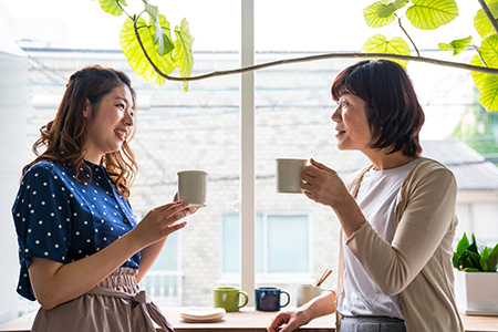 Older woman and teenager talking in a kitchen