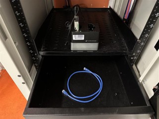 Photos showing an ethernet cable inside equipment cabinets storage drawer