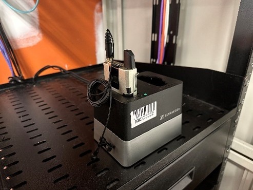 Photo showing the location of the Lavalier microphone in its charging cradle on the equipment cabinet shelf