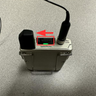 Photo showing an un-muted Lavalier microphone with the status LED lit green