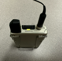 Photo showing an muted Lavalier microphone with the status LED lit yellow