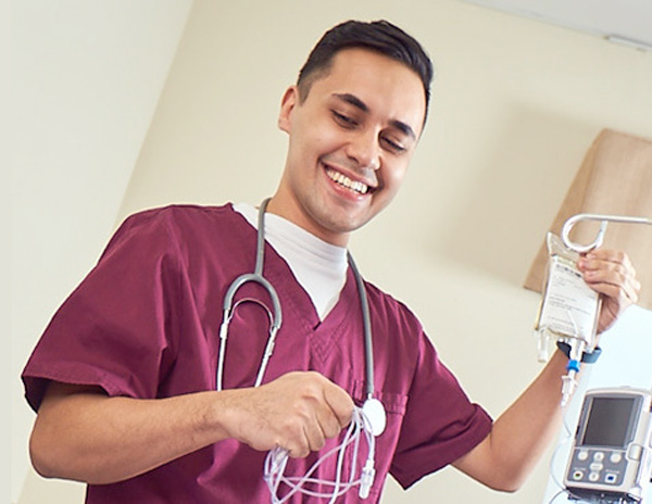 Smiling nurse working with a patient
