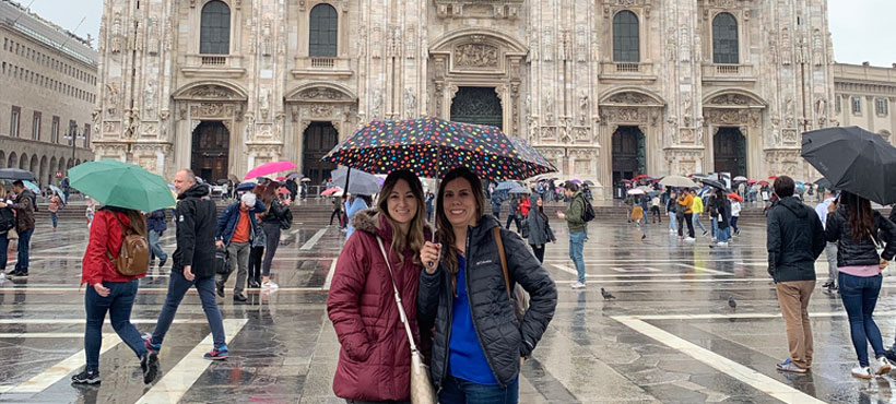 Two ladies in standing in front of an old building in Italy