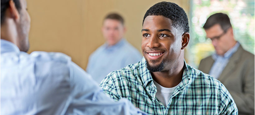 a student shaking hand with an employee