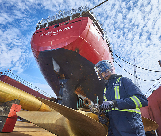 Worker performing helix part repair at shipyard